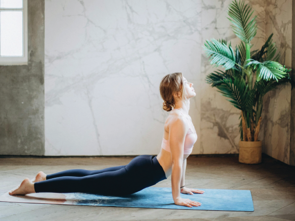 A woman demonstrating the cobra pose in yoga.